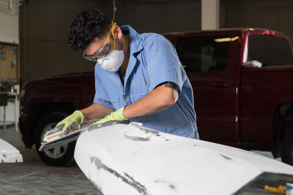 Auto Collision worker, sanding.